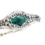 double pointed chrysocolla gemstone center wrapped in varying sizes of smooth pyrite ball gemstones in a sterling silver cuff bracelet