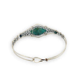 double pointed chrysocolla gemstone center wrapped in varying sizes of smooth pyrite ball gemstones in a sterling silver cuff bracelet