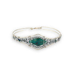 double pointed chrysocolla gemstone center wrapped in varying sizes of smooth pyrite ball gemstones in a sterling silver cuff bracelet