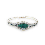 double pointed chrysocolla gemstone center wrapped in varying sizes of smooth pyrite ball gemstones in a sterling silver cuff bracelet