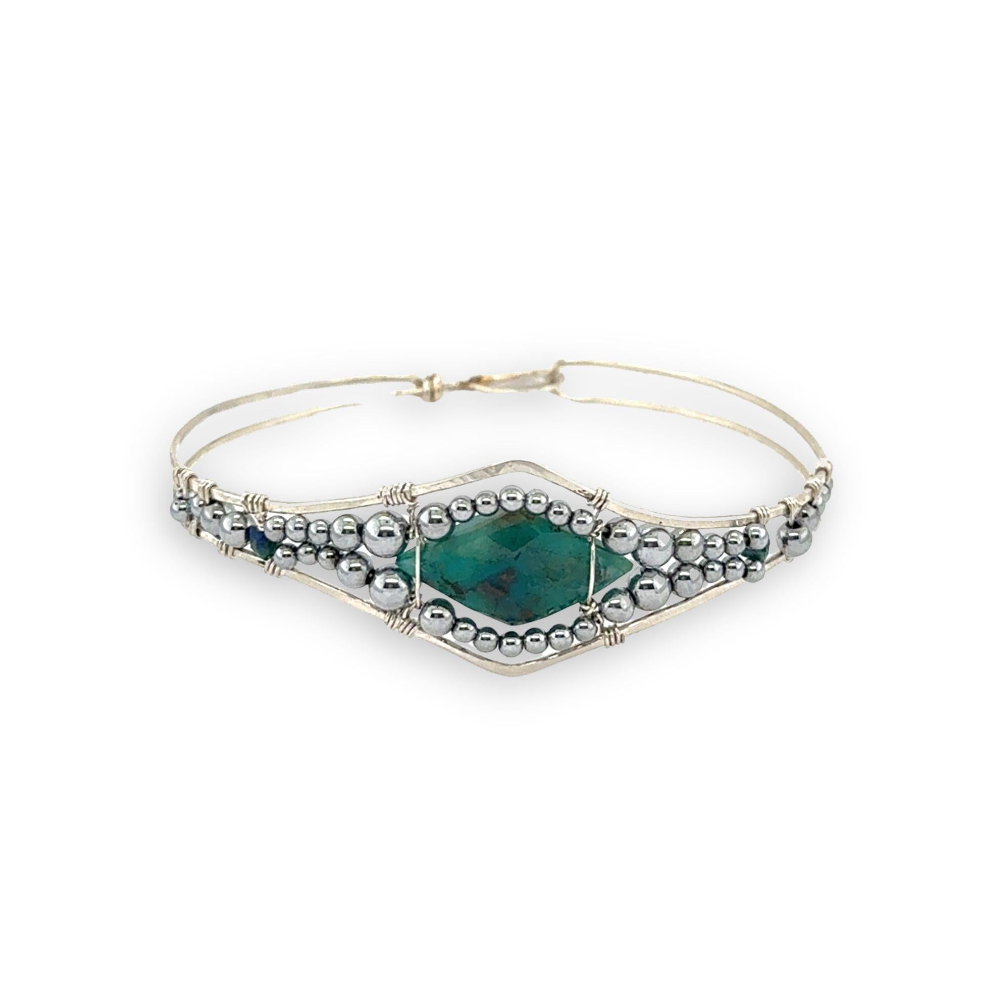 double pointed chrysocolla gemstone center wrapped in varying sizes of smooth pyrite ball gemstones in a sterling silver cuff bracelet