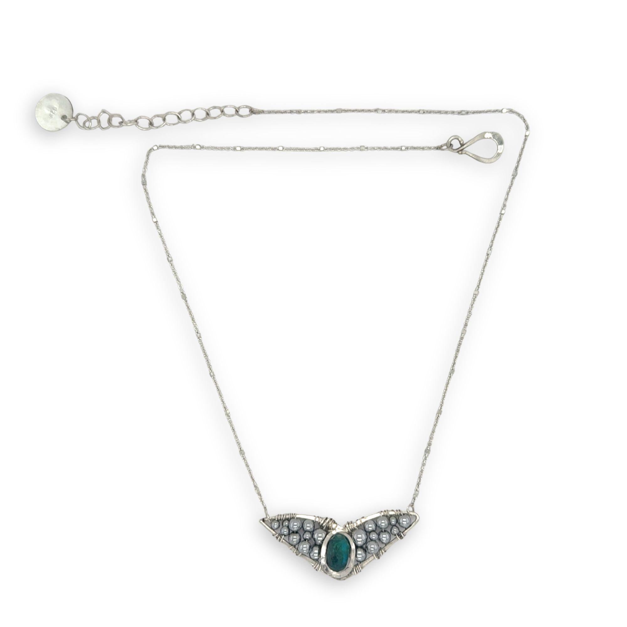 Necklace with sterling silver wings shaped pendant featuring a chrysocolla gemstone and smooth pyrite gemstones 