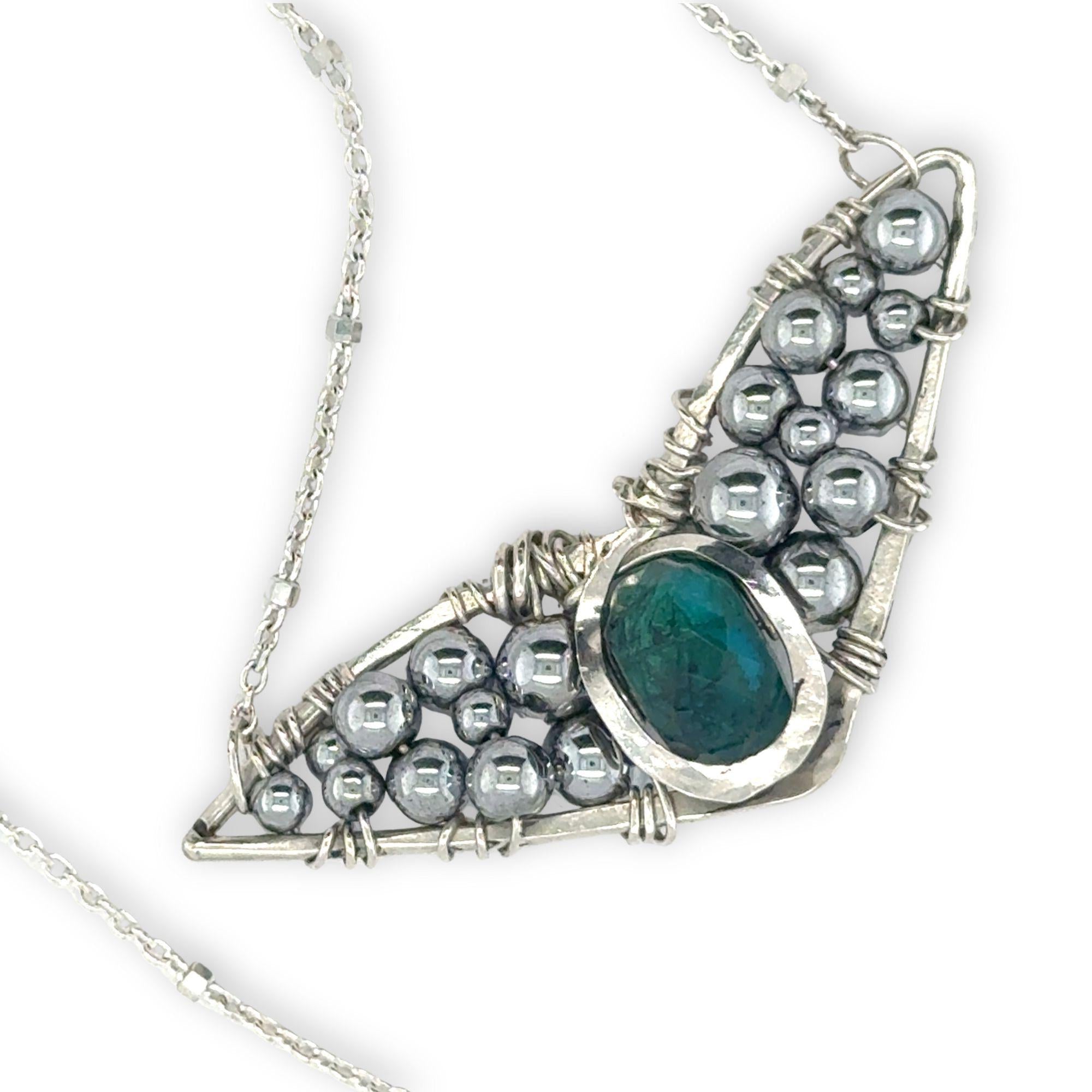 Necklace with sterling silver wings shaped pendant featuring a chrysocolla gemstone and smooth pyrite gemstones 