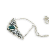 Necklace with sterling silver wings shaped pendant featuring a chrysocolla gemstone and smooth pyrite gemstones 