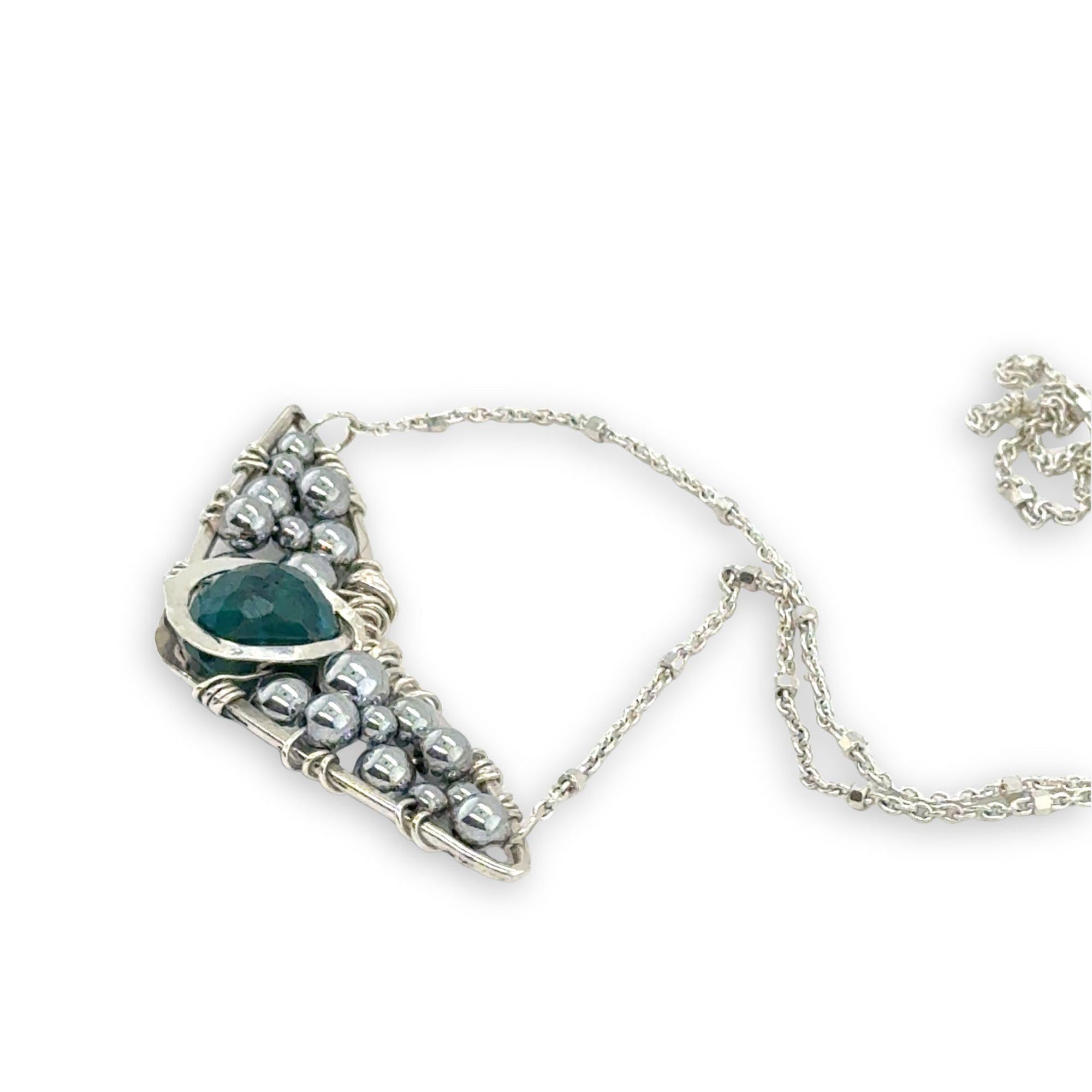 Necklace with sterling silver wings shaped pendant featuring a chrysocolla gemstone and smooth pyrite gemstones 