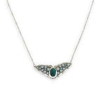 Necklace with sterling silver wings shaped pendant featuring a chrysocolla gemstone and smooth pyrite gemstones 