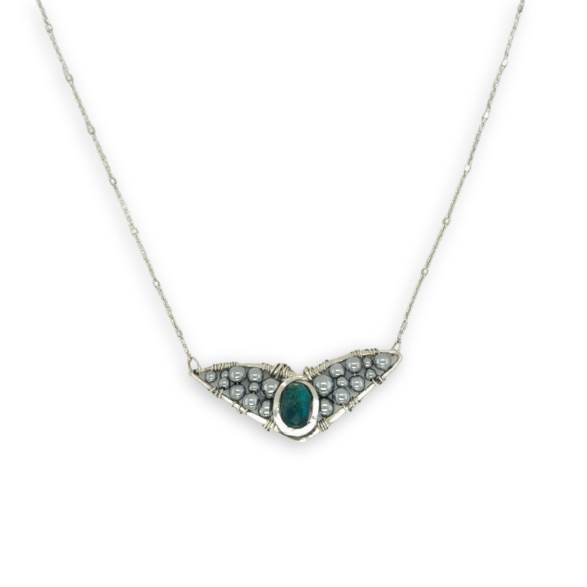 Necklace with sterling silver wings shaped pendant featuring a chrysocolla gemstone and smooth pyrite gemstones 