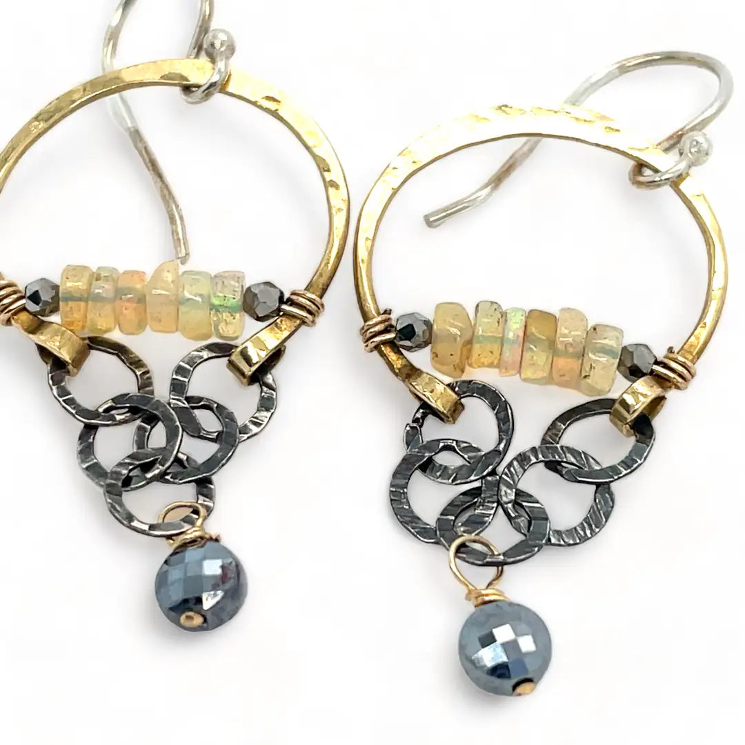 iridescent opal and pyrite gemstones accent our handmade brass hoop earrings with dark crinkle chain holding a pyrite faceted coin