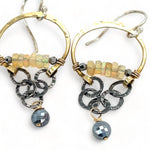 iridescent opal and pyrite gemstones accent our handmade brass hoop earrings with dark crinkle chain holding a pyrite faceted coin