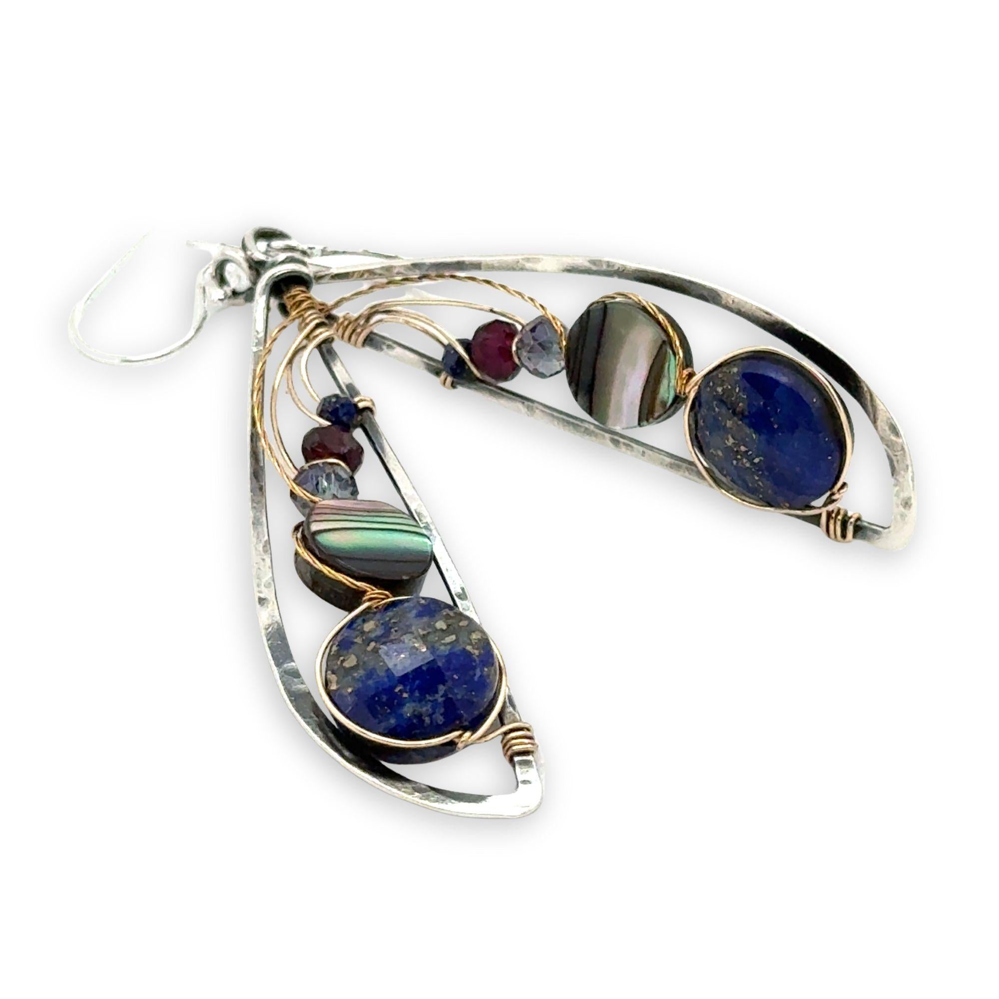 Darkened sterling silver hammered wing shaped earrings with lapis, abalone, crystal, and garnet gemstones wrapped in gold filled and brass twist wires