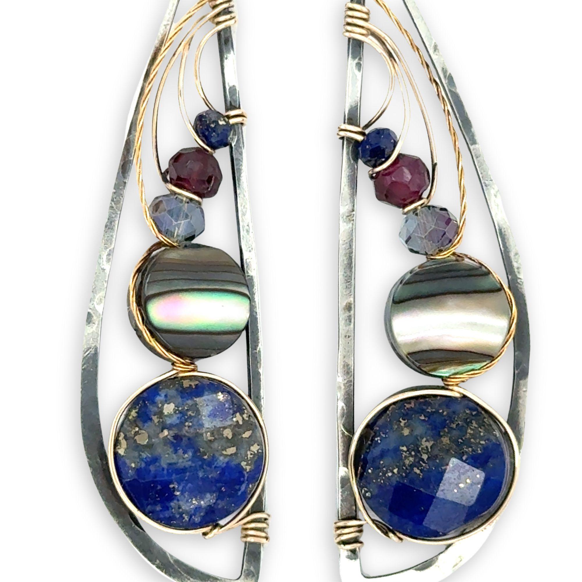 Darkened sterling silver hammered wing shaped earrings with lapis, abalone, crystal, and garnet gemstones wrapped in gold filled and brass twist wires
