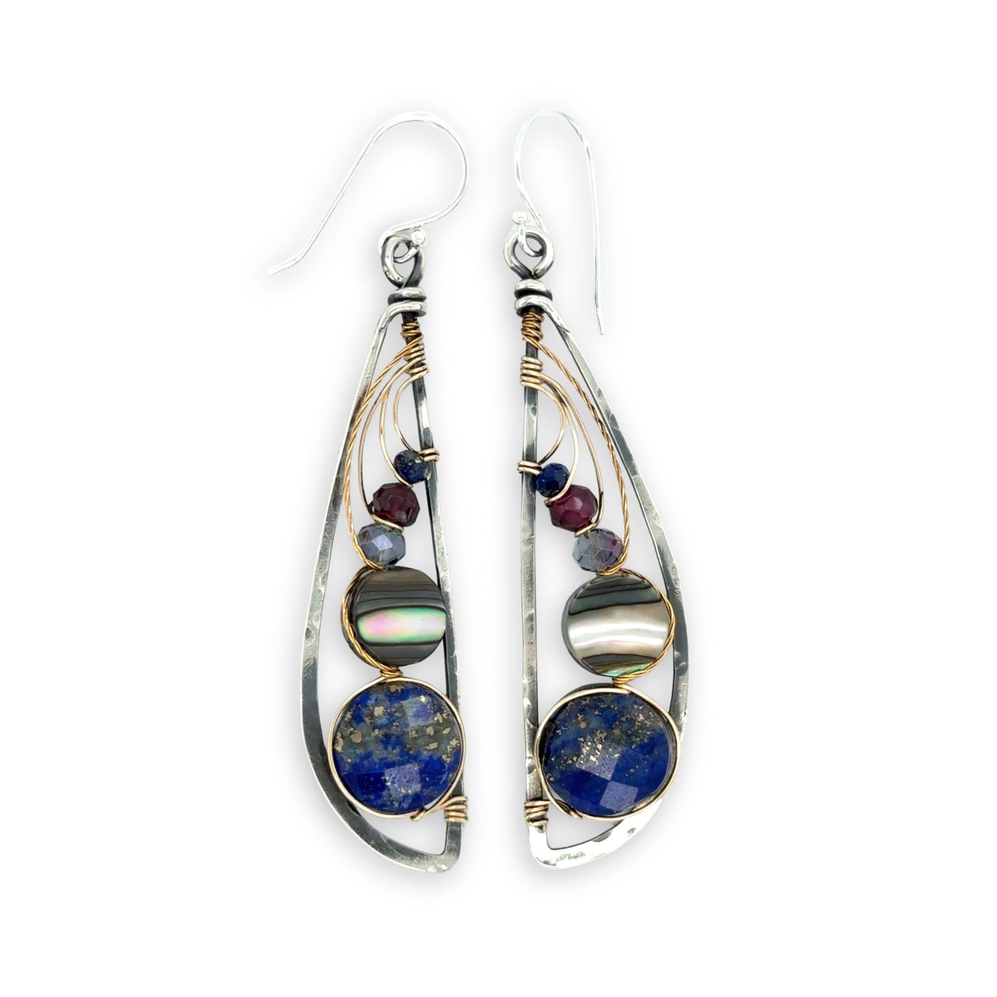 Darkened sterling silver hammered wing shaped earrings with lapis, abalone, crystal, and garnet gemstones wrapped in gold filled and brass twist wires