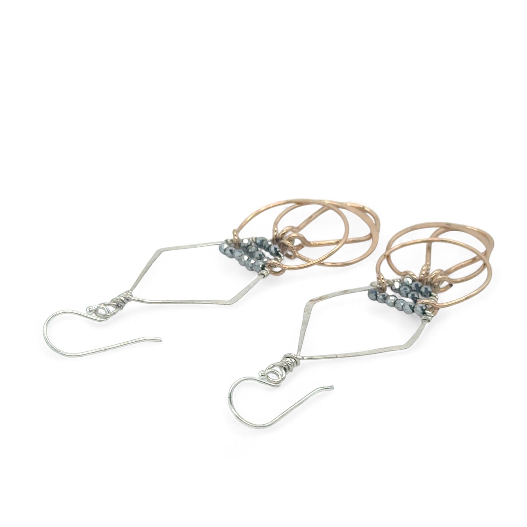 Sterling silver handmade diamond earrings with three bronze rings hanging from the bottom accented with silver pyrite gemstones