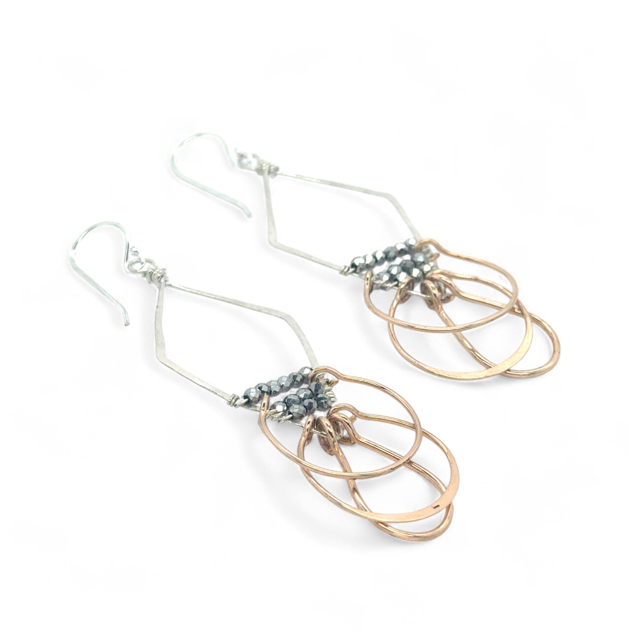Sterling silver handmade diamond earrings with three bronze rings hanging from the bottom accented with silver pyrite gemstones