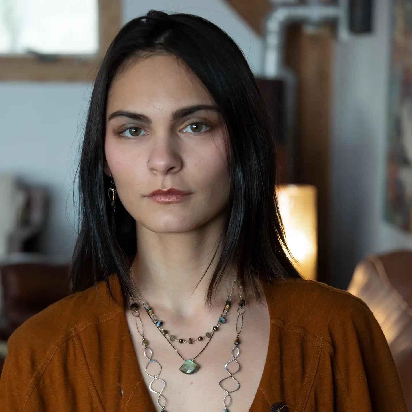 a flashy labradorite an gemstone is held on oxidized sterling silver dot chain with a second layer of cat's eye gemstones and fresh water pearl necklace