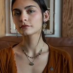 a flashy labradorite an gemstone is held on oxidized sterling silver dot chain with a second layer of cat's eye gemstones and fresh water pearl necklace