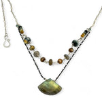 a flashy labradorite an gemstone is held on oxidized sterling silver dot chain with a second layer of cat's eye gemstones and fresh water pearl necklace