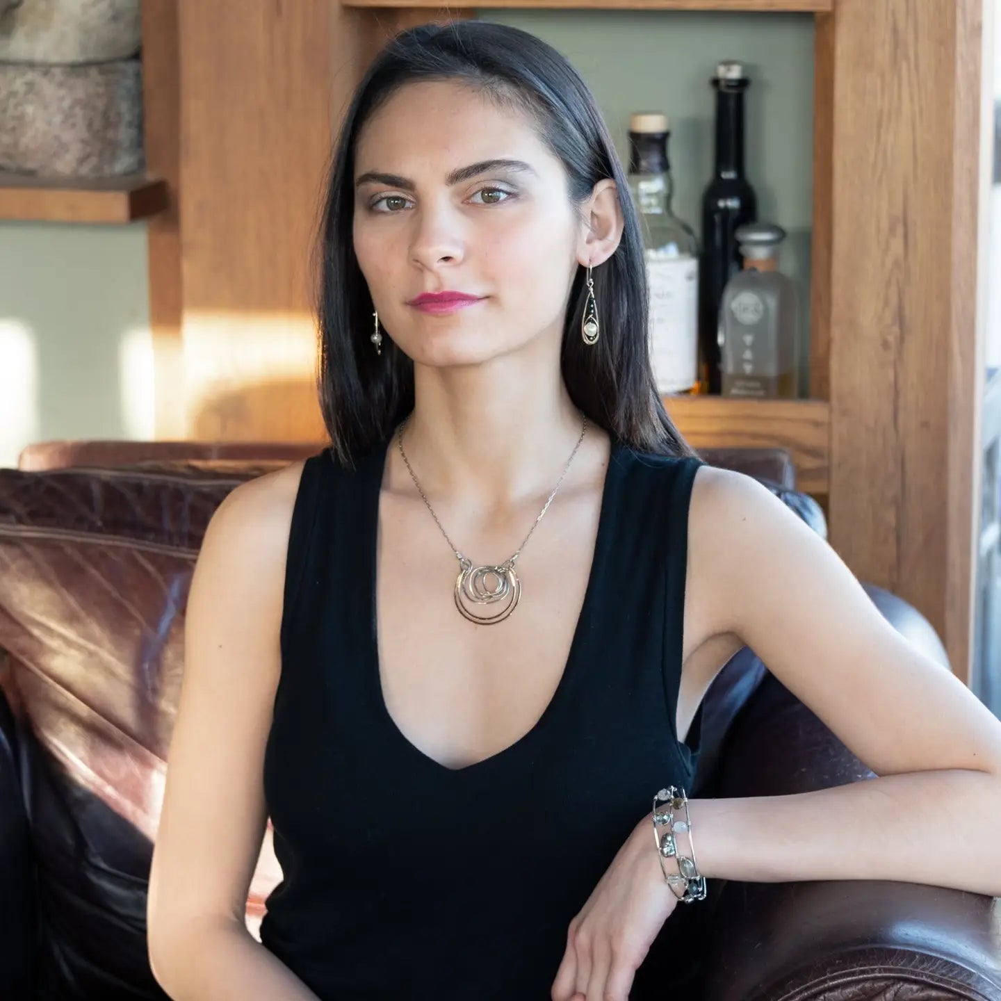 Handmade hammered and darkened sterling silver knot surrounded by hammered bronze large arches on a sterling silver tube chain necklace