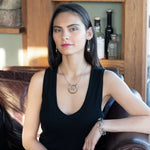 Handmade hammered and darkened sterling silver knot surrounded by hammered bronze large arches on a sterling silver tube chain necklace