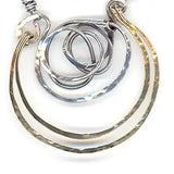 Handmade hammered and darkened sterling silver knot surrounded by hammered bronze large arches on a sterling silver tube chain necklace