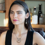 Handmade hammered and darkened sterling silver knot surrounded by hammered bronze large arches on a sterling silver tube chain necklace