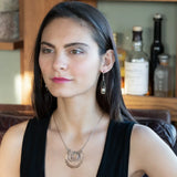 Handmade hammered and darkened sterling silver knot surrounded by hammered bronze large arches on a sterling silver tube chain necklace