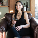 Handmade hammered and darkened sterling silver knot surrounded by hammered bronze large arches on a sterling silver tube chain necklace