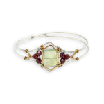 Sterling silver cuff bracelet with faceted serpentine jade rectangle at the center surrounded by faceted garnet gemstones and brass hammered wire