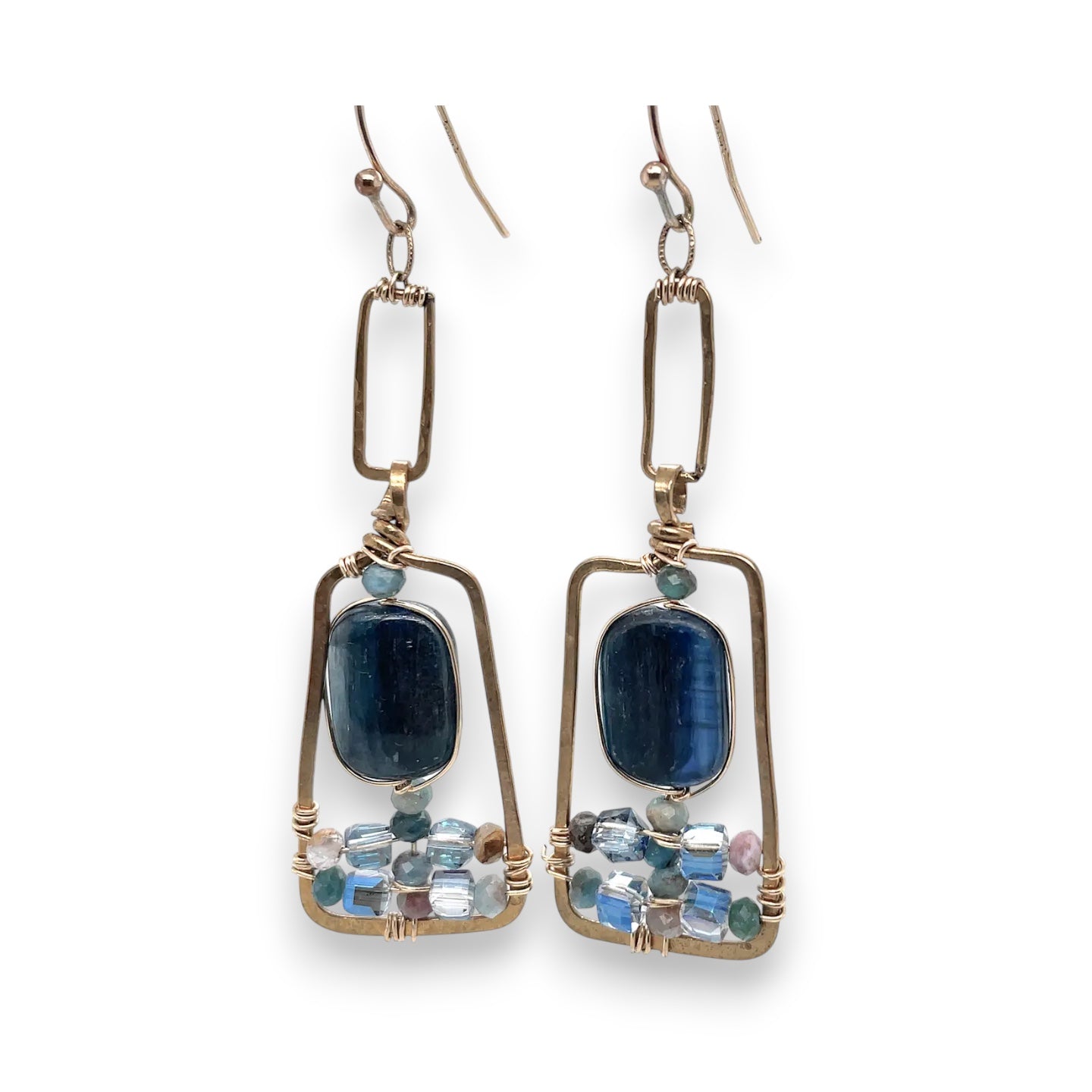 Smooth kyanite gemstones are accented with crystal cubes and blue tourmaline gemstones inside a brass rectangle earrings