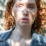 Smooth kyanite accented with crystal cubes and blue tourmaline gemstones inside a brass rectangle hanging from handmade hammered brass rectangle link necklace