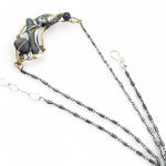 Brass crescent necklace on oxidized sterling silver tube chain with blue kyanite slice, mauve moonstone drop, crystal, iolite, and tourmalinated quartz gemstones on sterling silver wire necklace