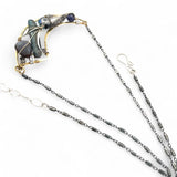 Brass crescent necklace on oxidized sterling silver tube chain with blue kyanite slice, mauve moonstone drop, crystal, iolite, and tourmalinated quartz gemstones on sterling silver wire necklace