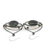 darkened sterling silver fat drop earrings with brass, gold fill and blue crystal accents featuring a prominent flashy labradorite gemstone