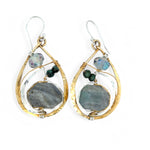 A pair of faceted labradorite earrings with emerald gemstones, set in layers of hammered sterling silver and brass leaf earrings, with sterling silver french hooks.