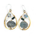 A pair of faceted labradorite earrings with emerald gemstones, set in layers of hammered sterling silver and brass leaf earrings, with sterling silver french hooks.