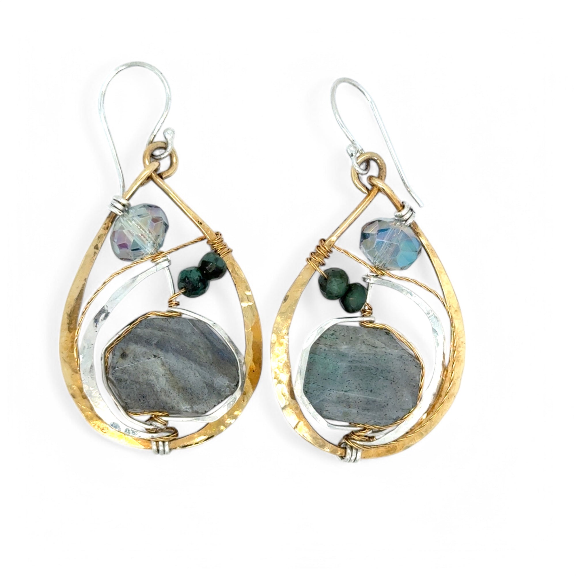 A pair of faceted labradorite earrings with emerald gemstones, set in layers of hammered sterling silver and brass leaf earrings, with sterling silver french hooks.