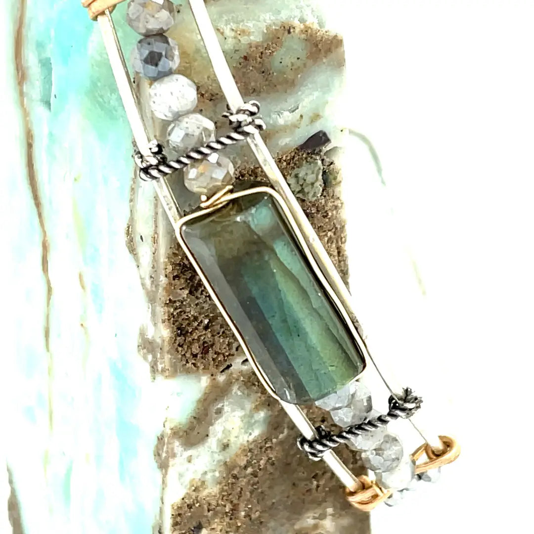 A stackable Labradorite and moonstone gemstone sterling silver skinny bracelet with twisted sterling silver and hammered bronze details