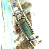 A stackable Labradorite and moonstone gemstone sterling silver skinny bracelet with twisted sterling silver and hammered bronze details