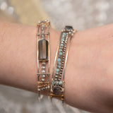 A stackable Labradorite and moonstone gemstone sterling silver skinny bracelet with twisted sterling silver and hammered bronze details