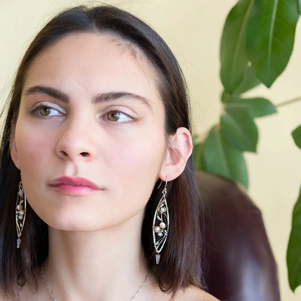 Long skinny sterling silver darkened marquise earrings embroidered with mother of pearl, fresh water pearl, and crystal gemstones on sterling silver and gold filled wire