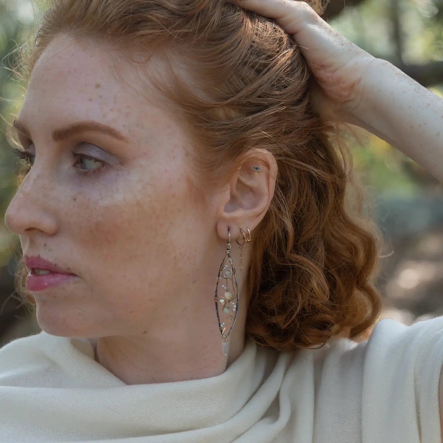 Long skinny sterling silver darkened marquise earrings embroidered with mother of pearl, fresh water pearl, and crystal gemstones on sterling silver and gold filled wire