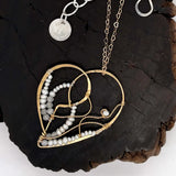 Brass heart necklace embroidered with tiny fresh water pearl and moonstone gemstones and brass twist accents on a delicate heart shaped gold filled chain