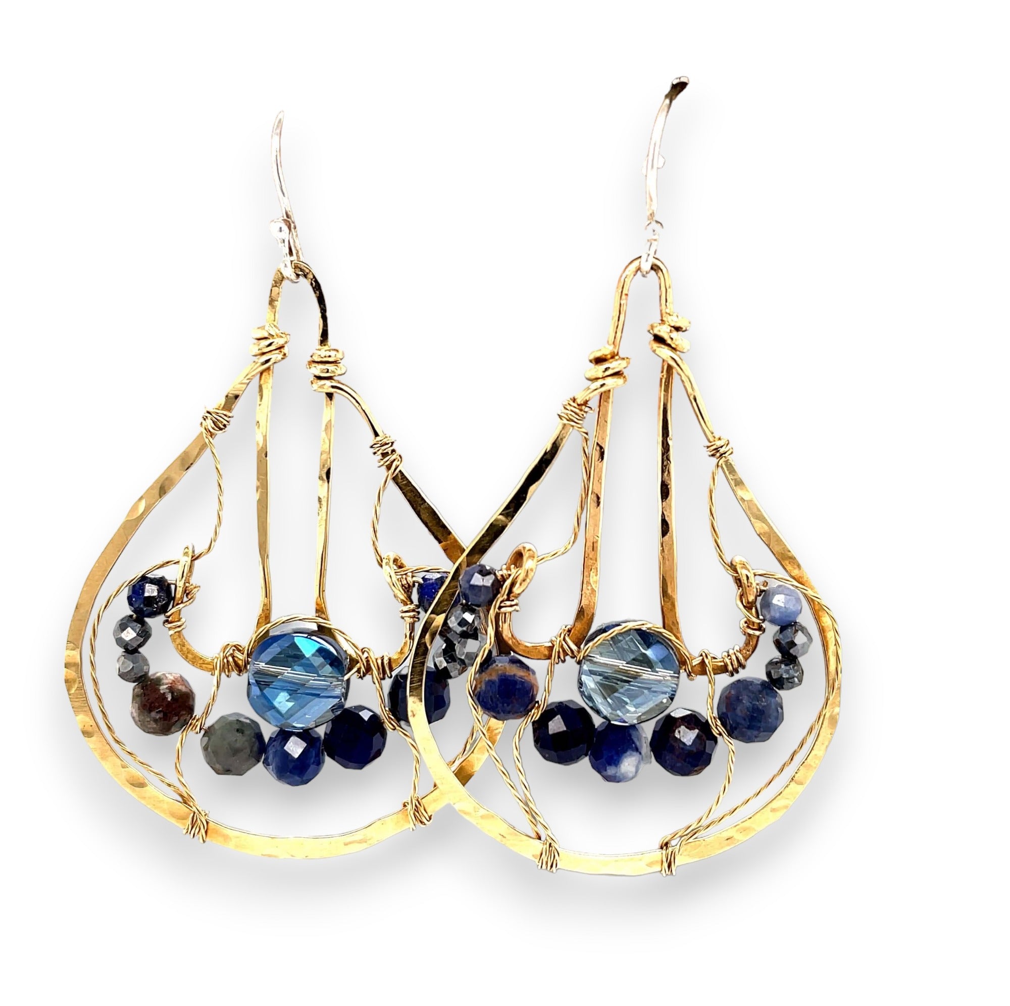 A pair of brass drop earrings featuring faceted lapis and sodalite gemstones and a crystal coin design, attached with gold filled and brass twist wires