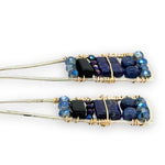 Lapis and onyx gemstones stacked with blue crystal on gold filled wire within a skinny, tall sterling silver triangle shaped earrings