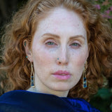 Lapis and onyx gemstones stacked with blue crystal on gold filled wire within a skinny, tall sterling silver triangle shaped earrings