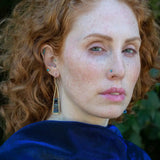 Lapis and onyx gemstones stacked with blue crystal on gold filled wire within a skinny, tall sterling silver triangle shaped earrings