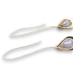 Lavender cubic zirconia drop gemstones sit inside tiny brass hammered teardrops on a long sterling silver earring hook