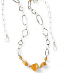 Citrine gemstone nuggets and handmade hammered geometric links are interspersed with sparkly sterling silver links to form this long chain necklace