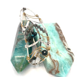 Bloodstone and labradorite faceted gemstones held within a sterling silver hand formed wave bracelet with oxidized sterling twist, gold filled wire and brass accents