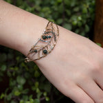 Bloodstone and labradorite faceted gemstones held within a sterling silver hand formed wave bracelet with oxidized sterling twist, gold filled wire and brass accents